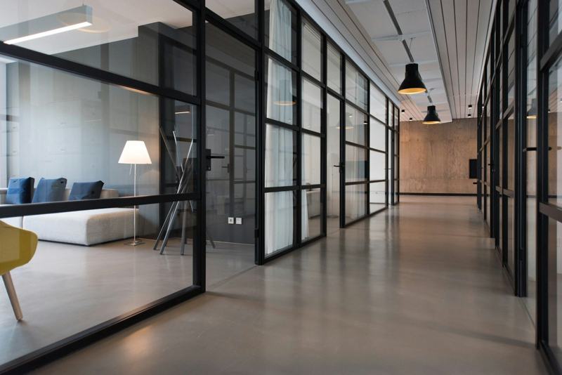 Office corridor with black-framed glass partitions